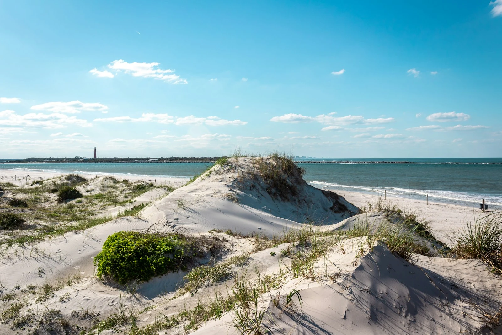 Sandy beach and ocean under a blue sky in New Smyrna Beach, Florida