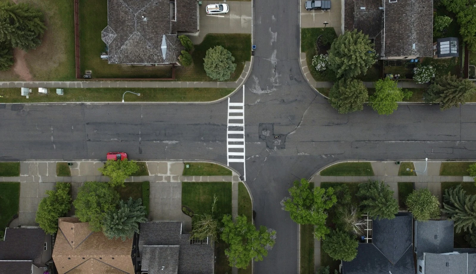 Aerial view of a suburban street intersection with crosswalk in Port Orange