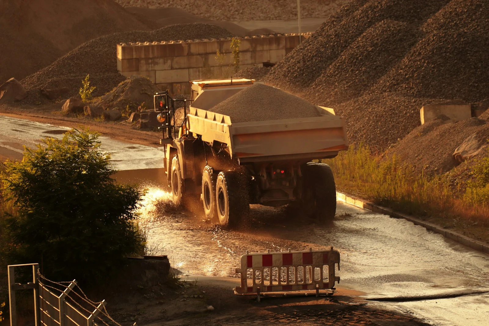 Dump truck on muddy road after storm debris clearing