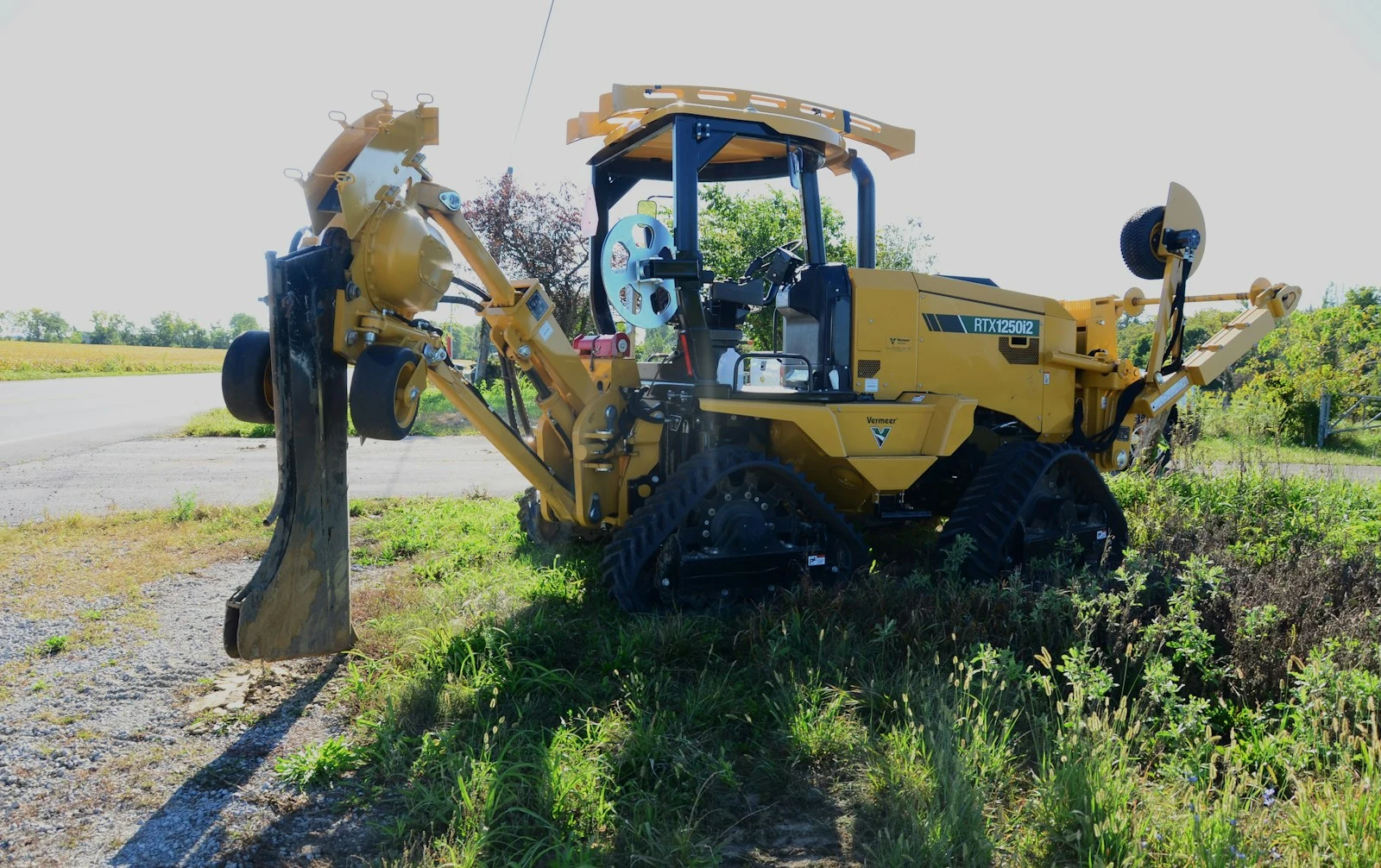 Yellow tractor parked in a field after land clearing in Sanford