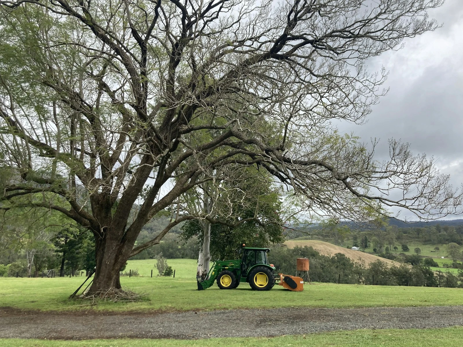 Tractor performing land clearing work on commercial site