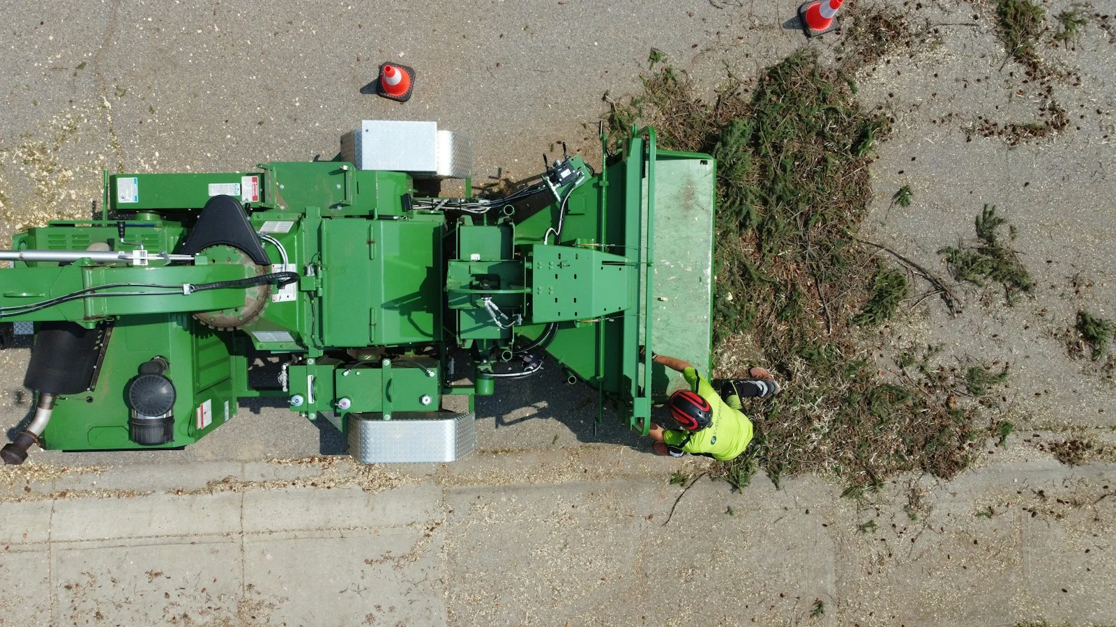 Green agricultural machine processing plant material during forestry mulching