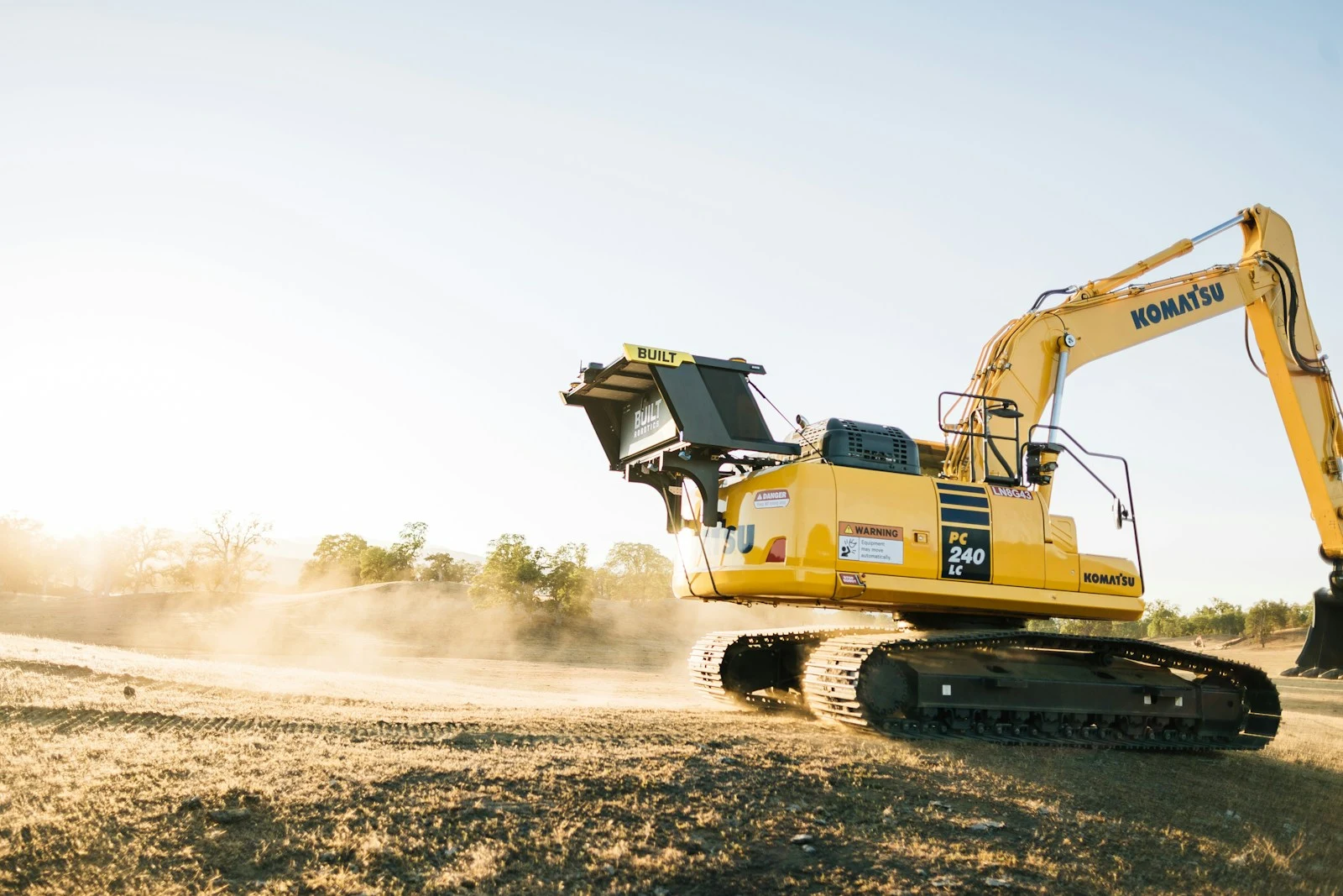 Construction vehicle clearing a path through overgrowth