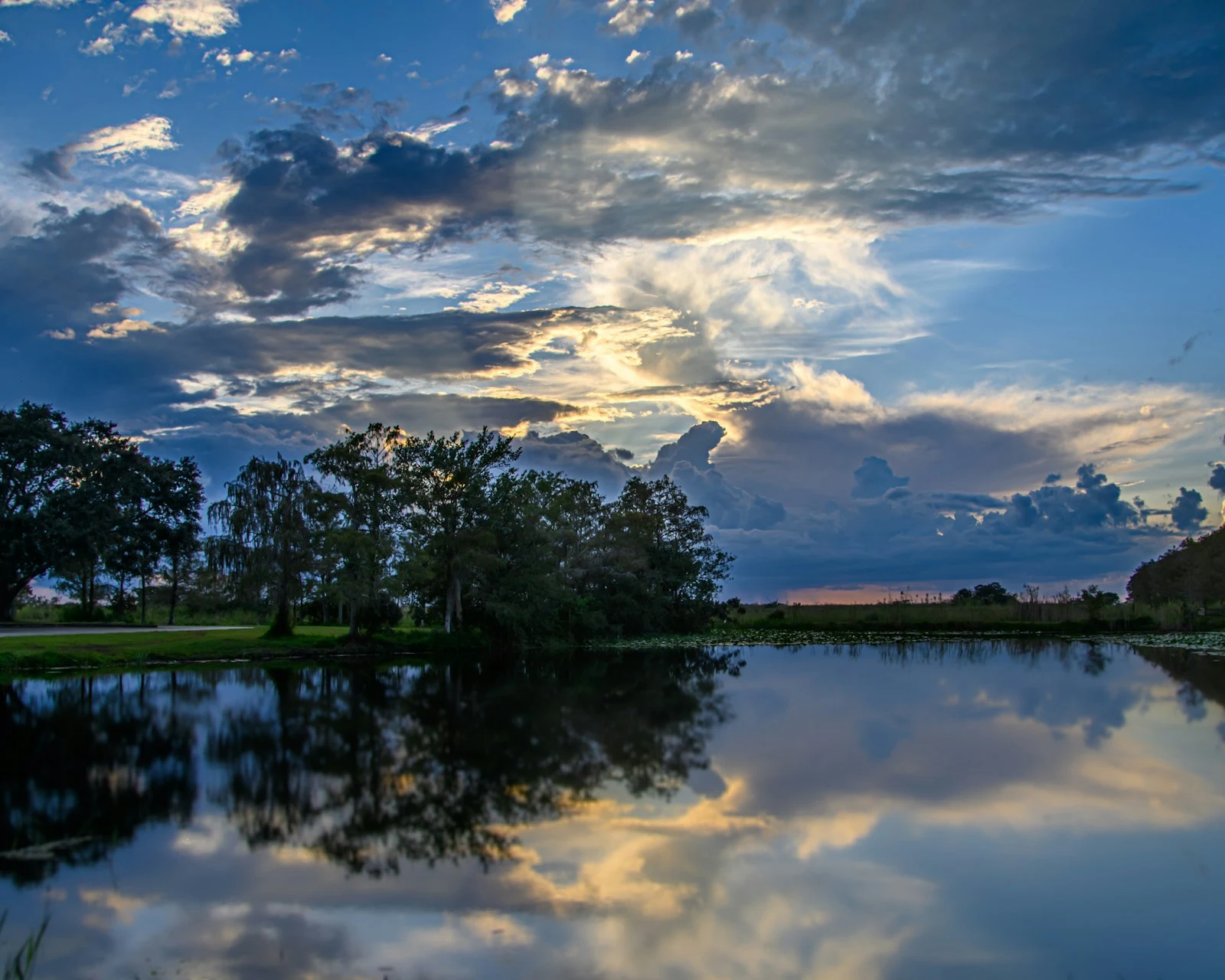 Calm lake with trees and clouds in Lake Helen, Florida