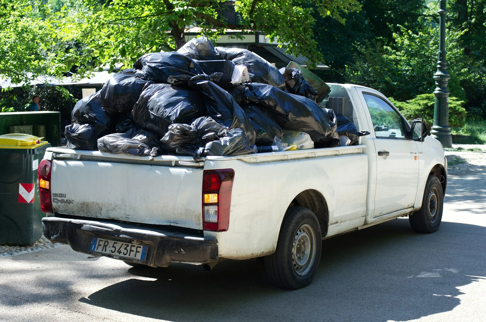Truck overloaded with yard waste and green debris