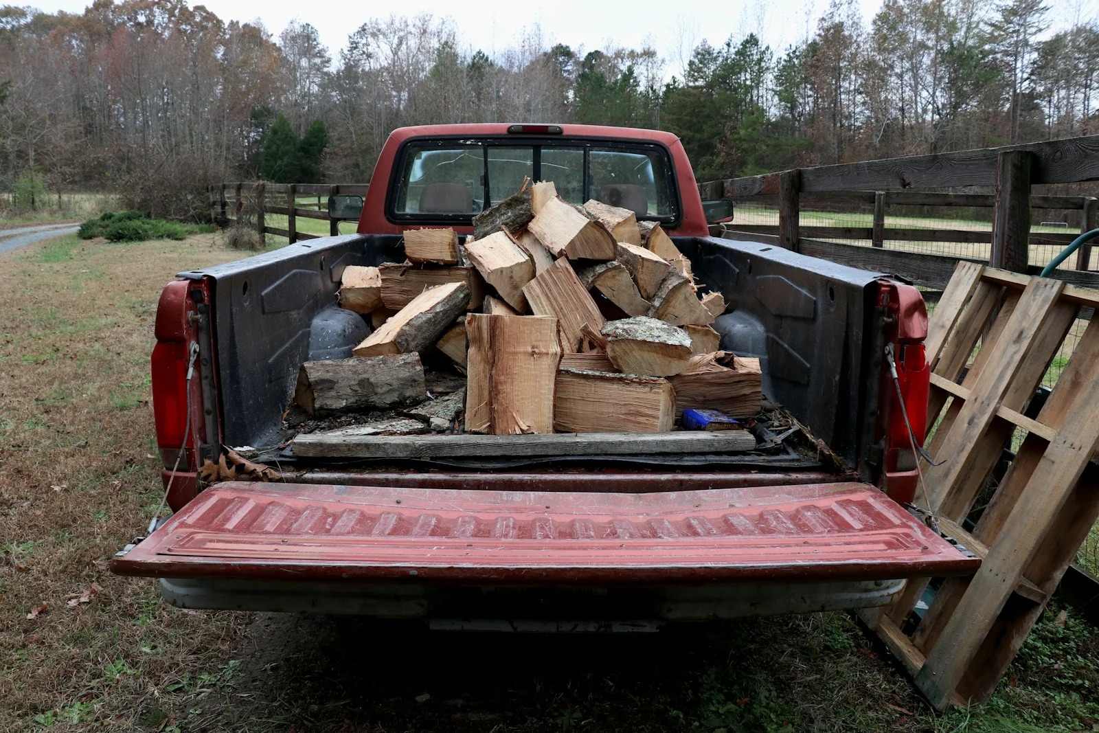 Grapple truck hauling bulk debris for property cleanup