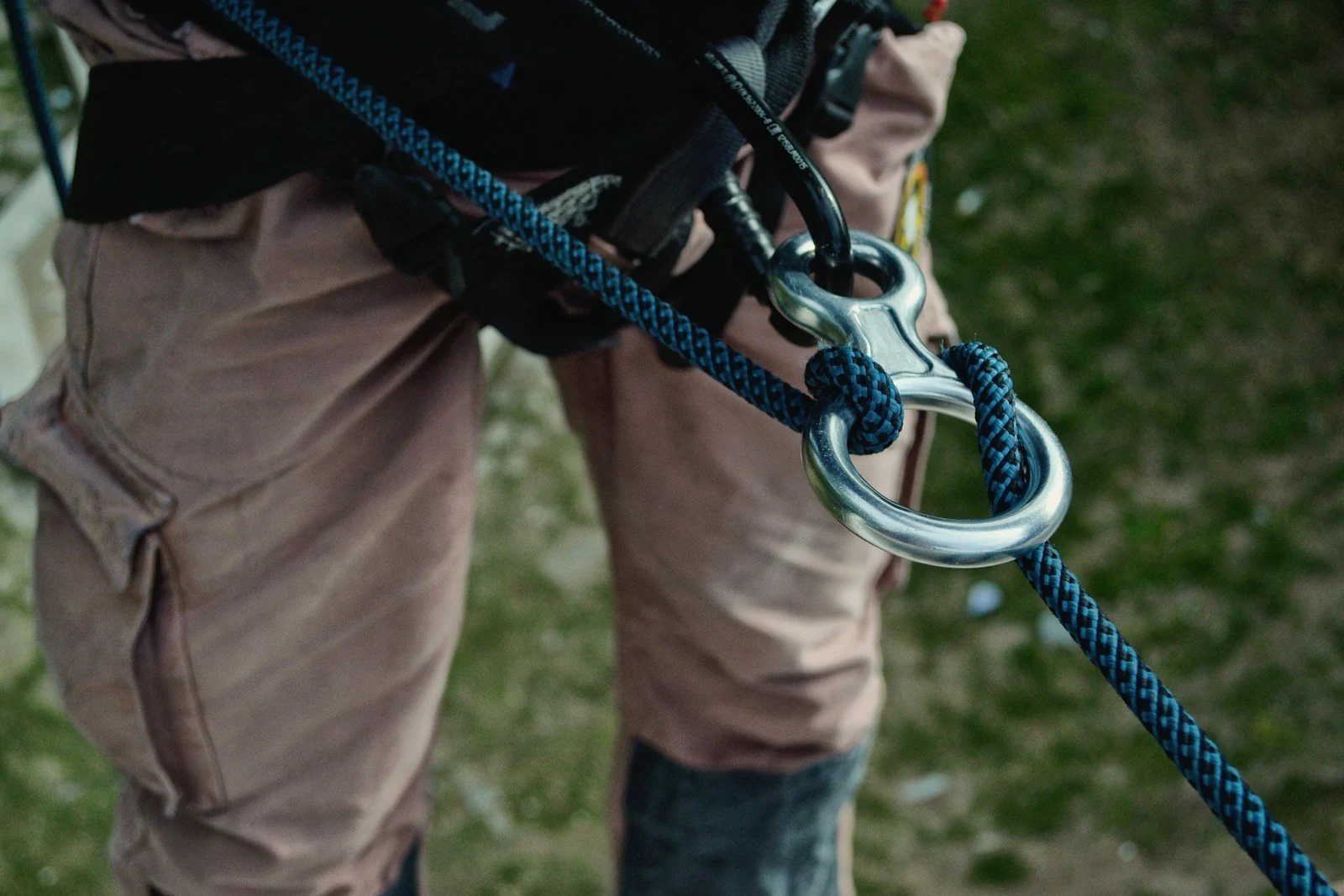 Certified arborist wearing safety harness during crane tree removal